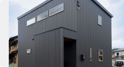 Charcoal modern building with three-dimensional metal siding