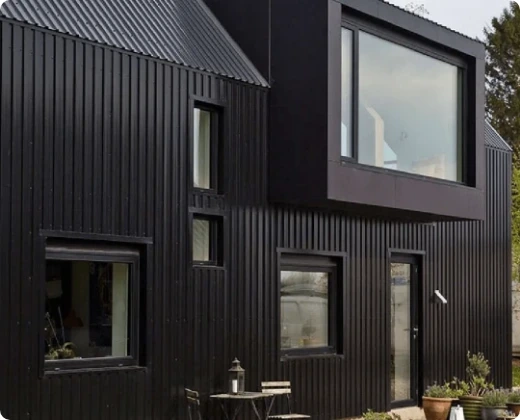 Modern house finished with black vertical metal siding