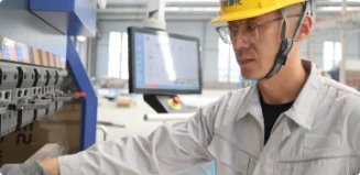 Factory technician operating production equipment